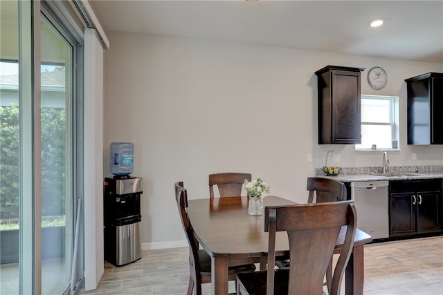 dining room with light hardwood / wood-style floors and sink