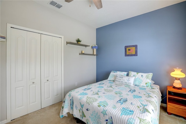 carpeted bedroom with ceiling fan and a closet