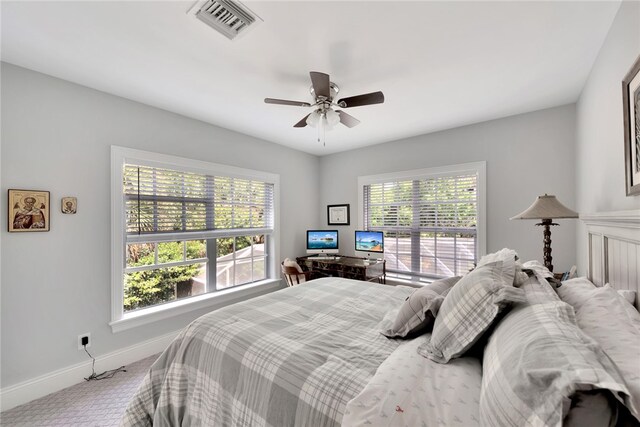 bedroom with multiple windows, carpet flooring, and ceiling fan