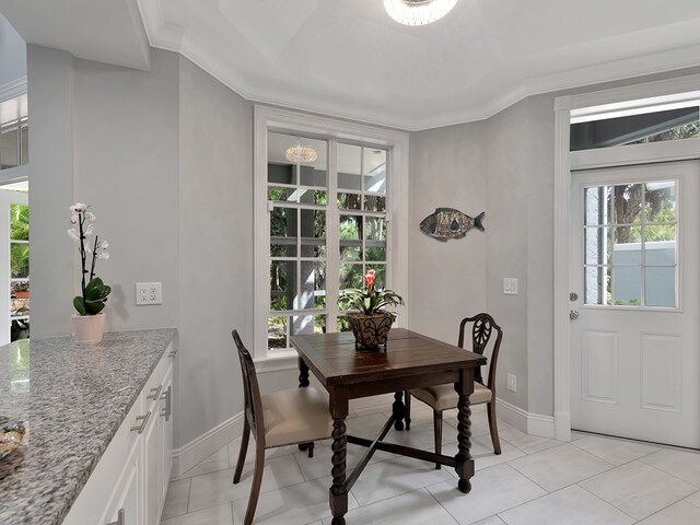 dining room featuring light tile patterned floors and ornamental molding