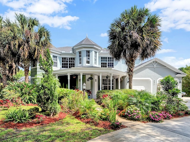 view of front of property featuring a garage and a porch