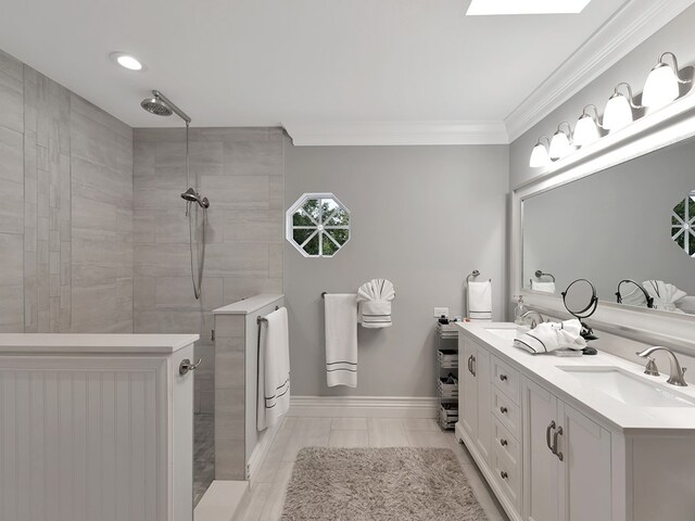 bathroom featuring ornamental molding, vanity, and a tile shower