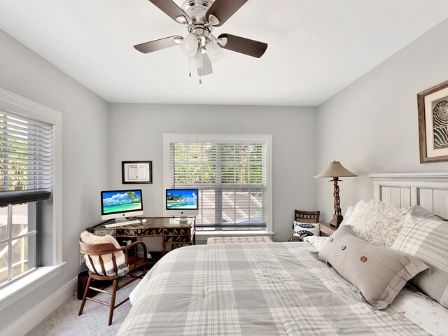 bedroom featuring multiple windows, ceiling fan, and carpet floors