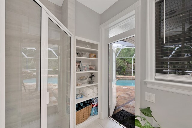 doorway to outside featuring light tile patterned flooring