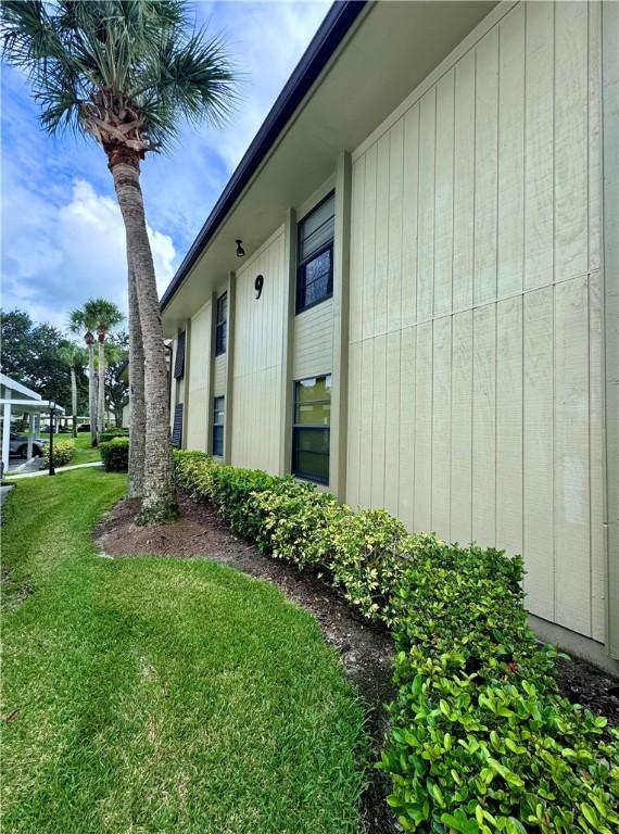 view of side of home with a lawn