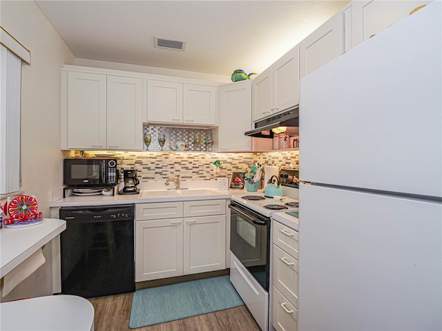 kitchen with wood-type flooring, sink, white cabinetry, and black appliances