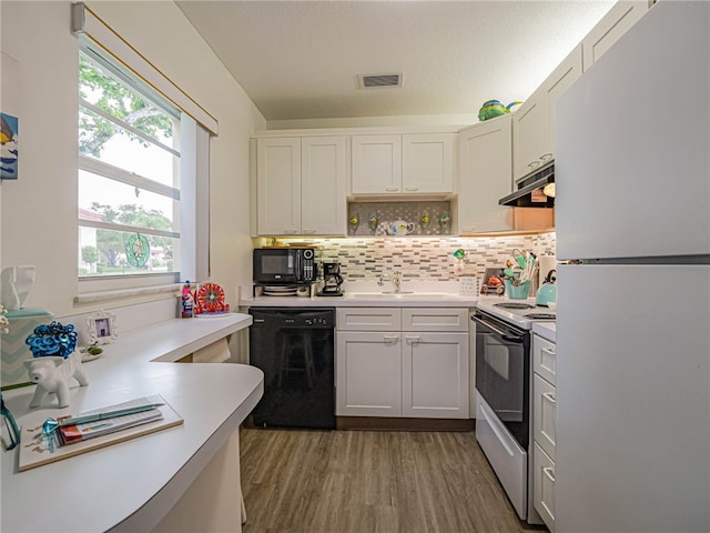 kitchen featuring backsplash, sink, black appliances, dark hardwood / wood-style floors, and white cabinetry