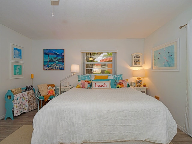 bedroom with hardwood / wood-style flooring and ceiling fan