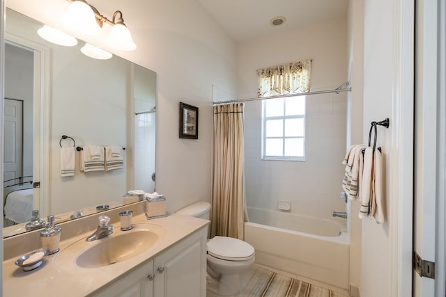 full bathroom featuring vanity, toilet, and shower / tub combo