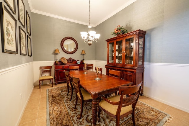 dining area featuring an inviting chandelier, light tile patterned floors, and ornamental molding