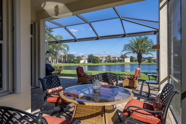 view of patio / terrace with a water view and a lanai