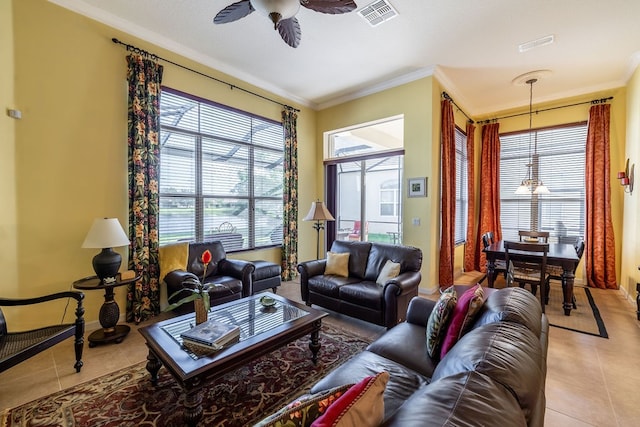 living room with light tile patterned flooring, ceiling fan, and crown molding