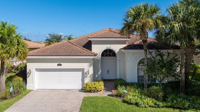 mediterranean / spanish-style house with a garage