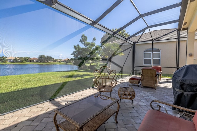 view of patio with a water view, glass enclosure, and area for grilling