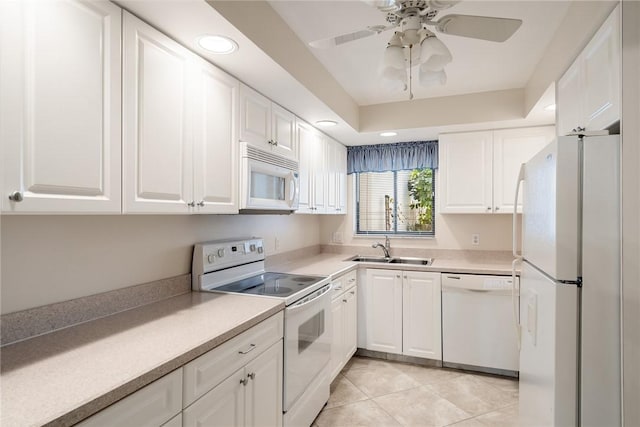 kitchen with white appliances, white cabinets, sink, ceiling fan, and light tile patterned floors