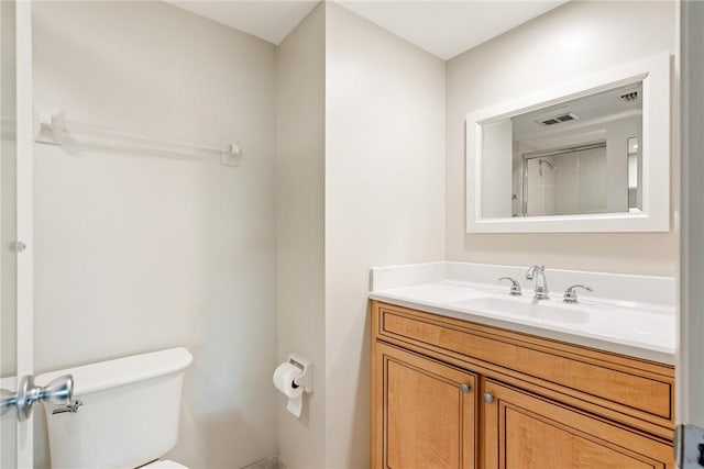 bathroom featuring toilet and vanity