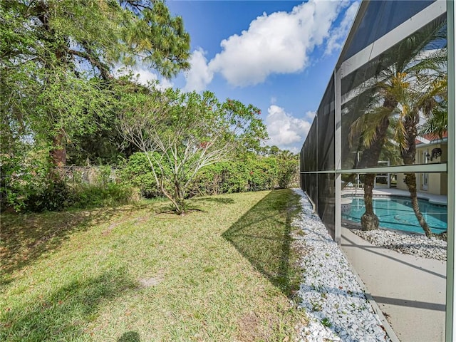 view of yard featuring an outdoor pool and glass enclosure