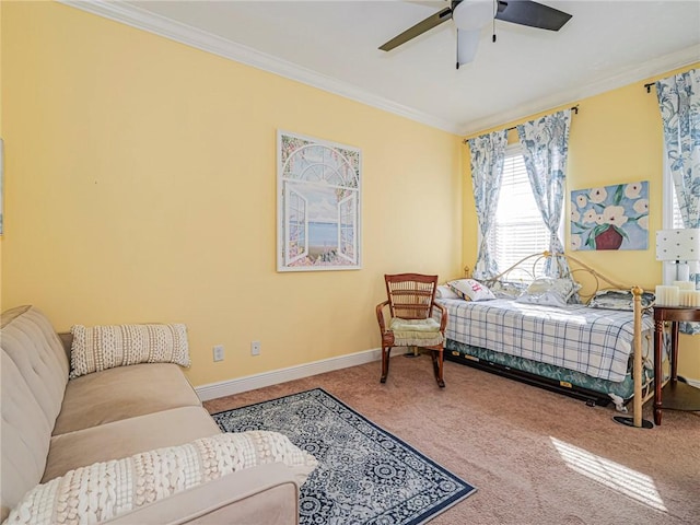 carpeted bedroom featuring baseboards, ceiling fan, and crown molding