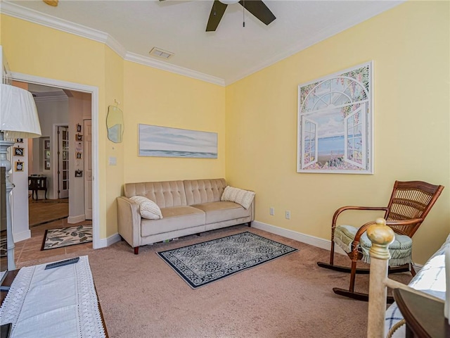 living area featuring carpet floors, baseboards, ceiling fan, and ornamental molding
