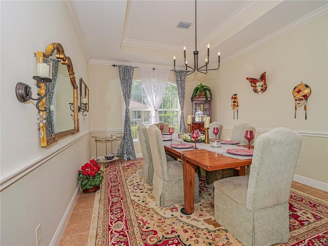 tiled dining area with crown molding, an inviting chandelier, baseboards, a raised ceiling, and visible vents