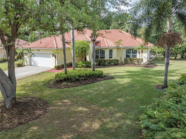 mediterranean / spanish-style house featuring a front yard, concrete driveway, stucco siding, an attached garage, and a tiled roof