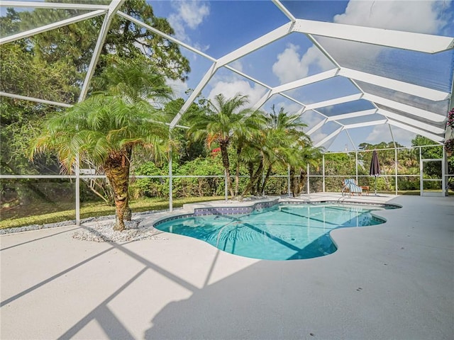 pool featuring a patio and glass enclosure