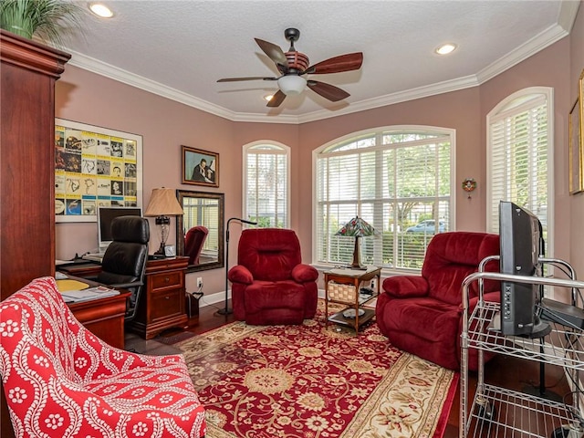office featuring wood finished floors, a textured ceiling, baseboards, ceiling fan, and ornamental molding