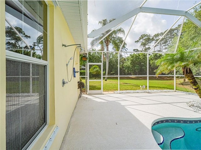 outdoor pool with glass enclosure, a yard, and a patio area