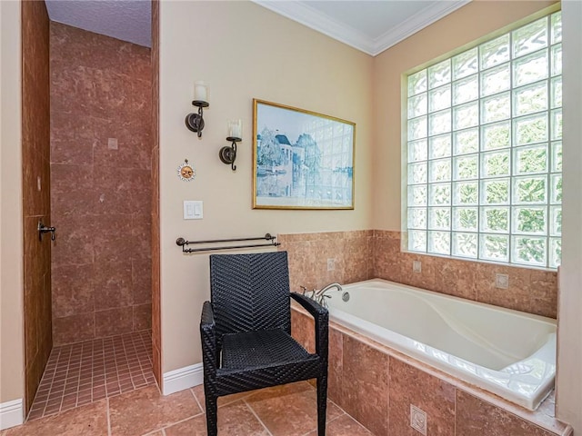 bathroom featuring a tile shower, crown molding, baseboards, and a garden tub