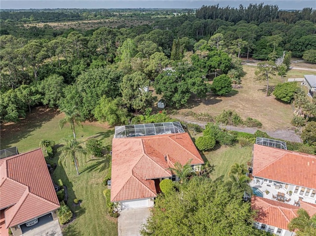 birds eye view of property with a wooded view