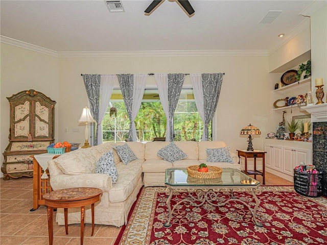 living area featuring light tile patterned floors, ornamental molding, visible vents, and a ceiling fan
