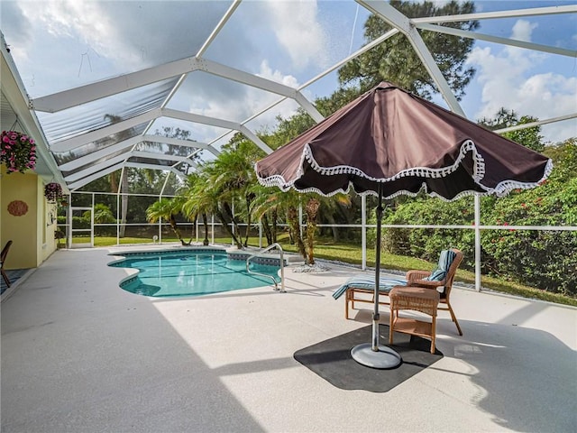 outdoor pool with glass enclosure and a patio