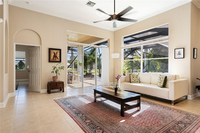 living room with light tile patterned floors, visible vents, a sunroom, ornamental molding, and ceiling fan