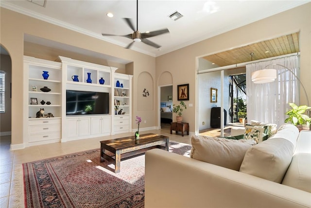 living room featuring visible vents, ornamental molding, light tile patterned floors, arched walkways, and a ceiling fan