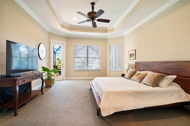 bedroom featuring a tray ceiling, carpet floors, crown molding, baseboards, and access to exterior