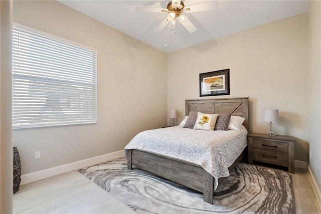 bedroom with wood finished floors, baseboards, and ceiling fan