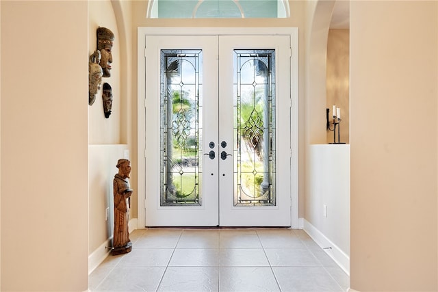 doorway to outside with french doors, a healthy amount of sunlight, and light tile patterned floors