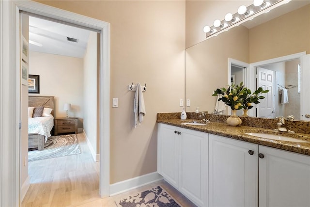 ensuite bathroom featuring a sink, visible vents, double vanity, and ensuite bathroom