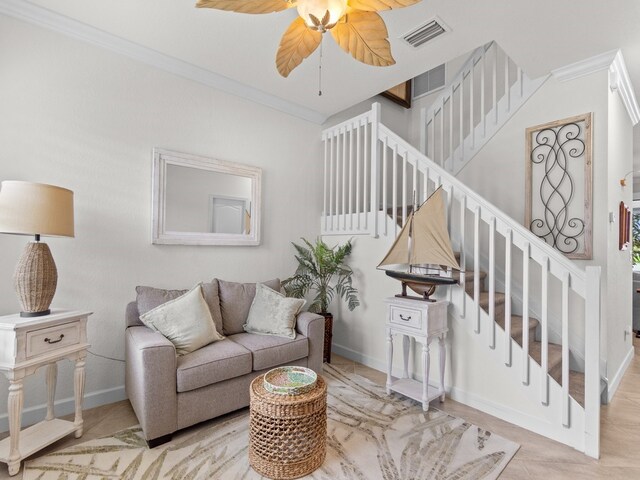 living room featuring ornamental molding and ceiling fan