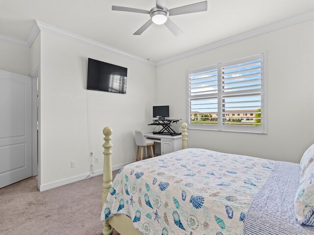 bedroom featuring ornamental molding, light colored carpet, and ceiling fan