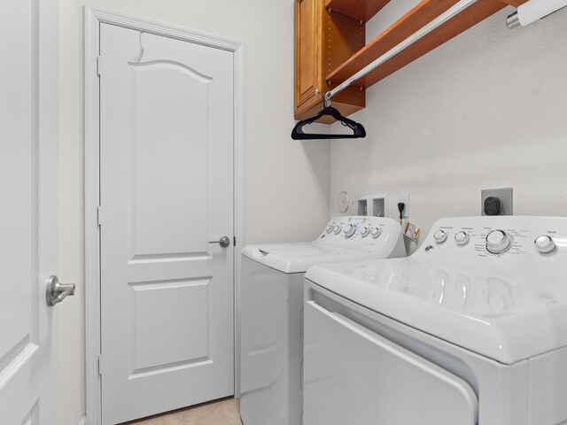 washroom with cabinets and independent washer and dryer