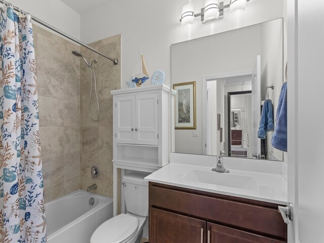 full bathroom featuring shower / tub combo with curtain, vanity, and toilet