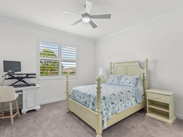 carpeted bedroom featuring ceiling fan and crown molding