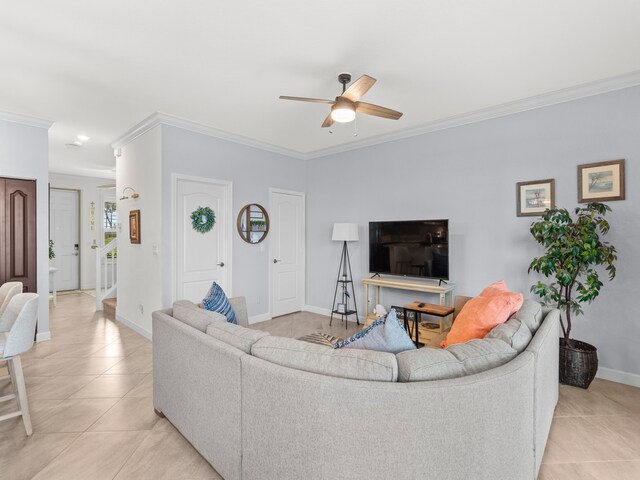 living room with ornamental molding, ceiling fan, and light tile patterned flooring