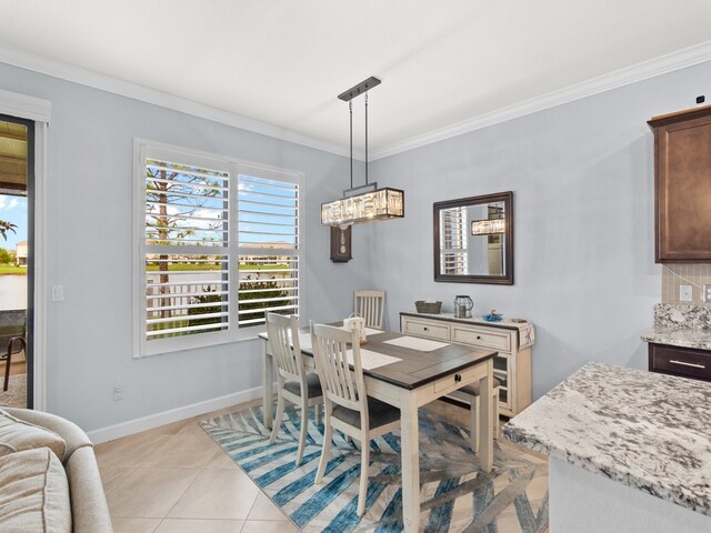 dining area featuring light tile patterned floors and crown molding