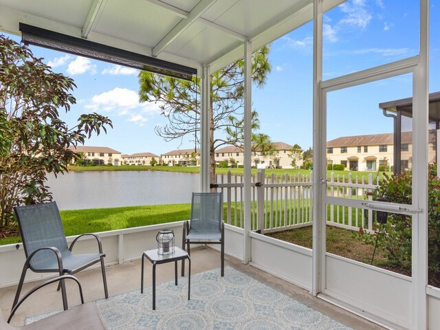 sunroom with a water view and a healthy amount of sunlight