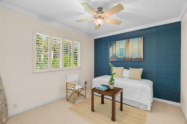 carpeted bedroom with crown molding, a ceiling fan, and baseboards