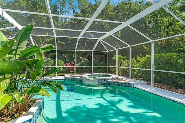 view of pool featuring a lanai and a pool with connected hot tub