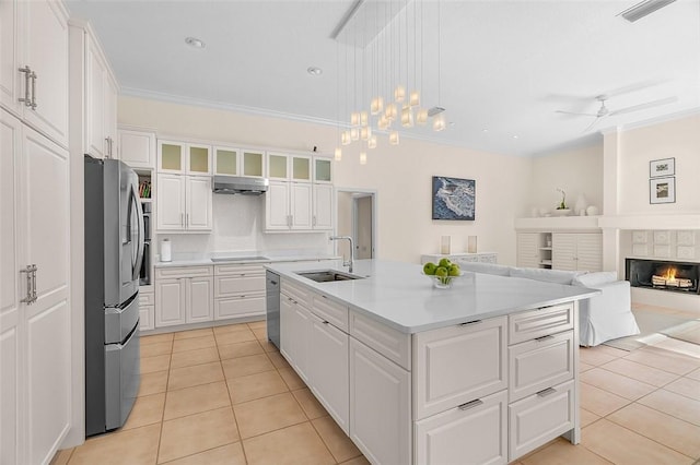 kitchen with a sink, white cabinetry, appliances with stainless steel finishes, and light tile patterned flooring