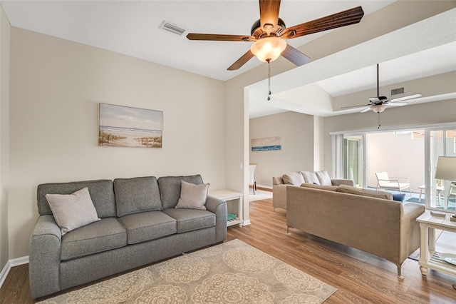 living room with vaulted ceiling, ceiling fan, and light hardwood / wood-style flooring